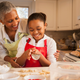 Grandmother and granddaughter baking cookies in kitchen